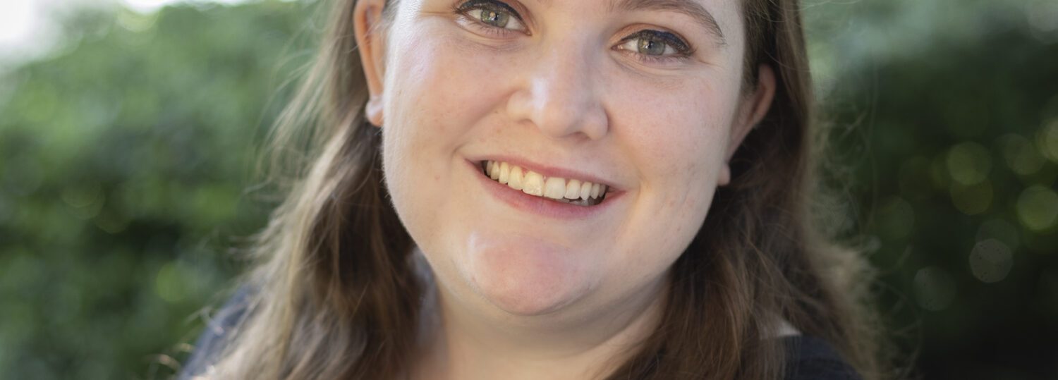 Headshot of Lisi wearing a black blouse
