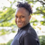 Headshot of Ormond wearing a black shirt with a collar.