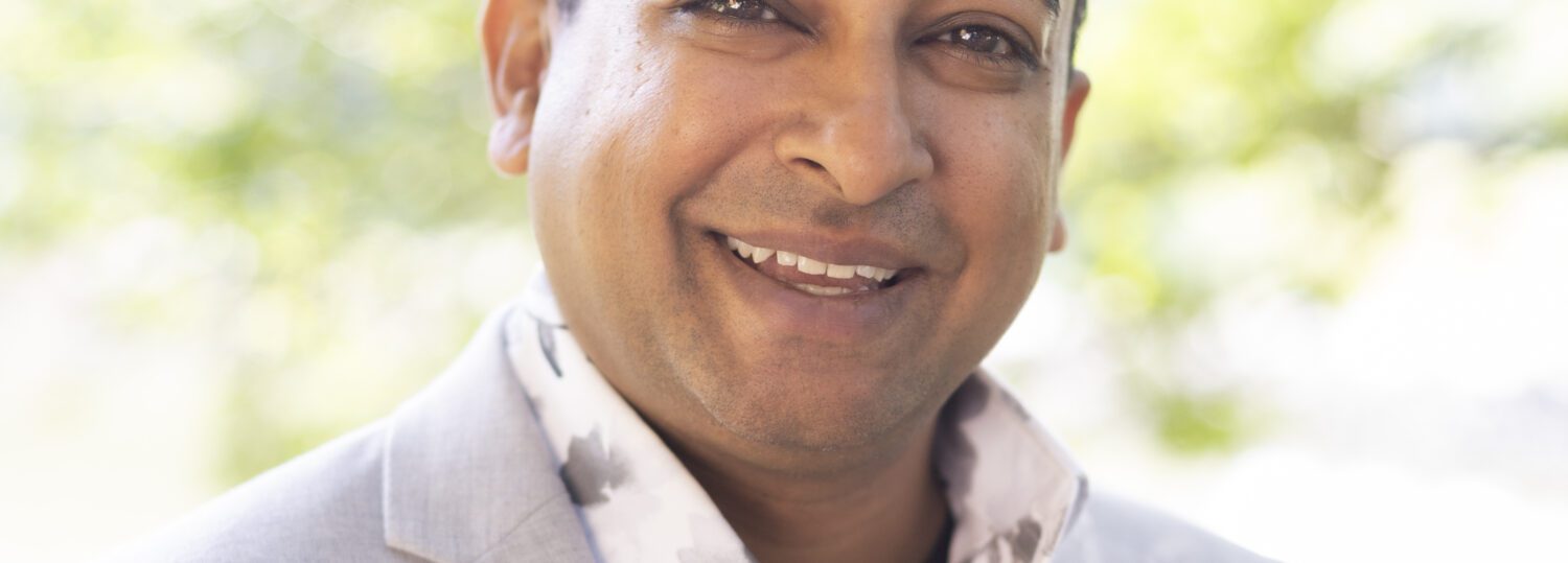 Headshot of Sathy wearing a light colored blazer.