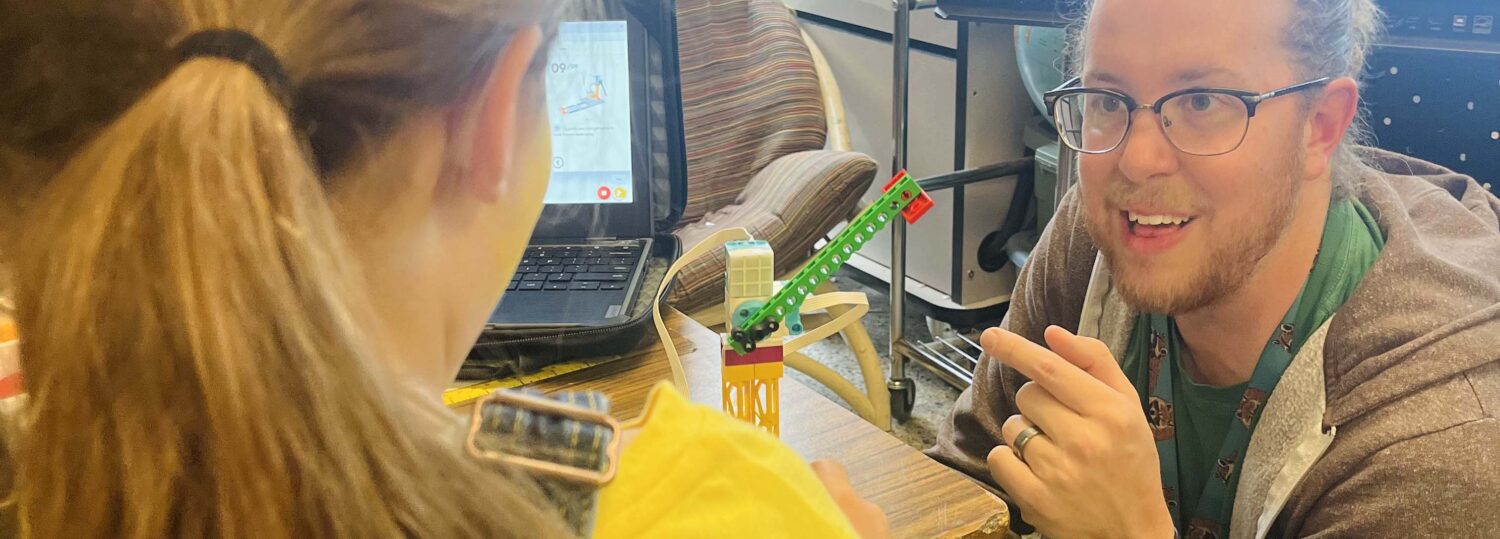 Kenan Fellow Trey Nichols works with a student on a clean energy lesson.