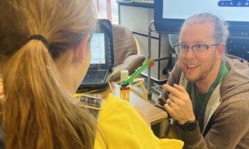 Kenan Fellow Trey Nichols works with a student on a clean energy lesson.
